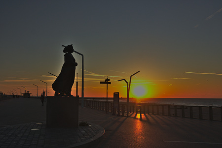 a statue in front of the sunsetの写真素材