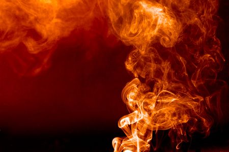 smoke against a black background resembling flamesの写真素材