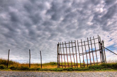 beautiful hdr scene of a fence and cloudscapeの写真素材
