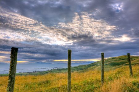 beautiful hdr scene of a fence and cloudscapeの写真素材