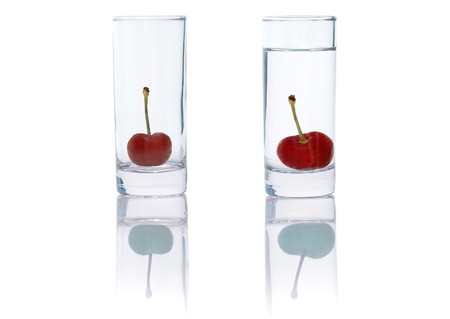 beautiful cherries in small glass isolated over a white backgroundの写真素材