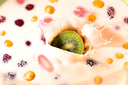 beautiful kiwi splash on milk with some fruit on itの写真素材