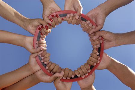 Hands together creating a sun against a blue skyの写真素材