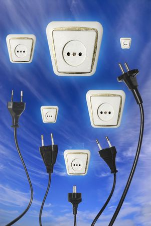 Plugs reaching outlet in the skyの写真素材