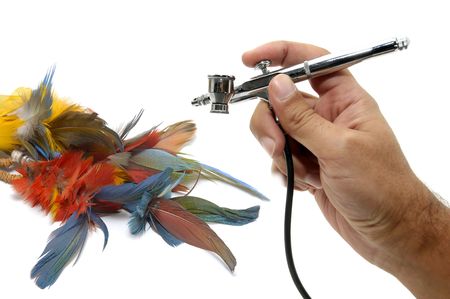 Hand with airbrush painting isolated in whiteの写真素材