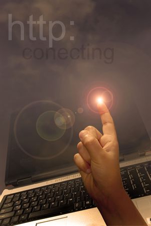 Finger pointing, with laptop on the background