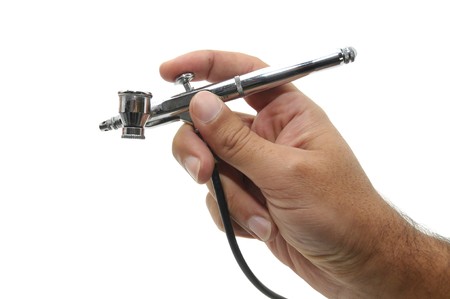 Hand with airbrush isolated in whiteの写真素材