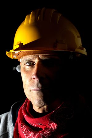 Portrait of a worker isolated in black
