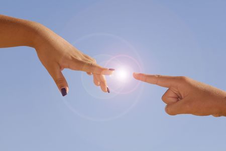 Hands allmost touching against a blue skyの写真素材