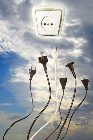 Plugs reaching outlet in the skyの写真素材