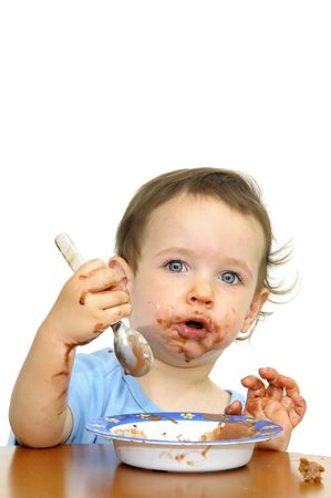 Beautiful blue eyed eating icecream with a spoon isolated in whiteの写真素材