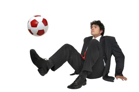 Businessman playing with a soccer ball  isolated in whiteの写真素材