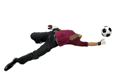 Businessman goalkeeper with gloves  in a acrobatic pose with a soccer ball isolated in whiteの写真素材