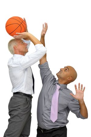 Two businessman with a basketball, playing isolated in whiteの写真素材