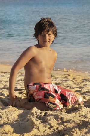 Young boy posing in the beachの写真素材