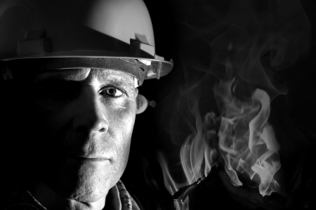 Portrait of a firemanr isolated in blackの写真素材