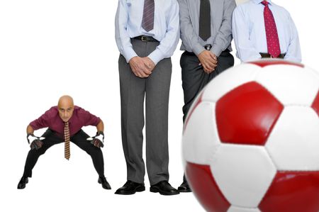 Businessmen playing  soccer isolated in whiteの写真素材