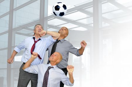 Businessmen playing  soccer in the officeの写真素材