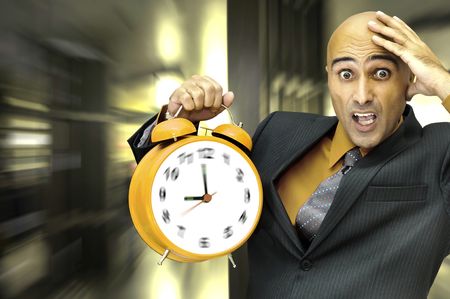 Businessman holding a big alarm clockの写真素材