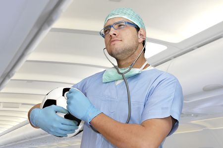 Doctor in uniform with soccer ball in the hospitalの写真素材