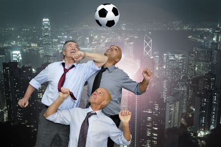 Businessmen playing  soccer outdoorsの写真素材