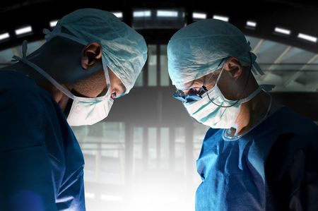 Doctors team in surgery in a dark backgroundの写真素材