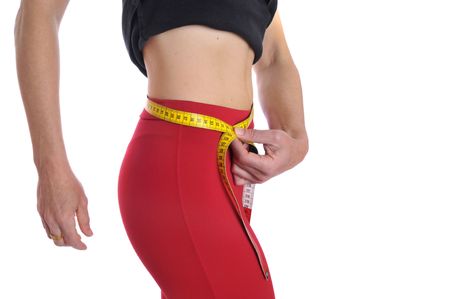 Fit woman body part with measuring tape isolated in whiteの写真素材