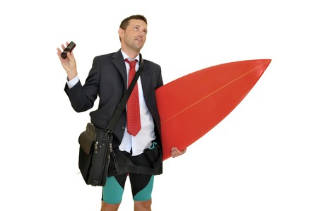 Young businessman with surf board recieving a call from the officeの写真素材