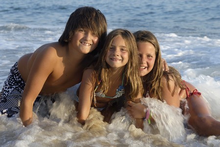 Three brothers posing in the beachの写真素材