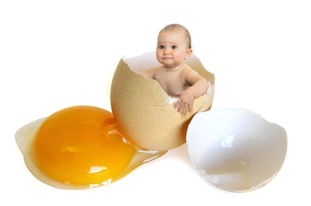 Beautiful baby inside an egg isolated in white