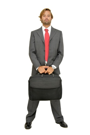 Handsome fashionable businessman posing with laptop case isolated in whiteの写真素材