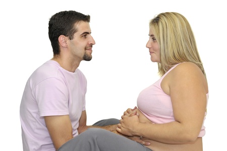 Happy pregnant couple isolated in whiteの写真素材