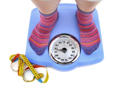 Fat woman body part in a scale and a measuring tapeの写真素材