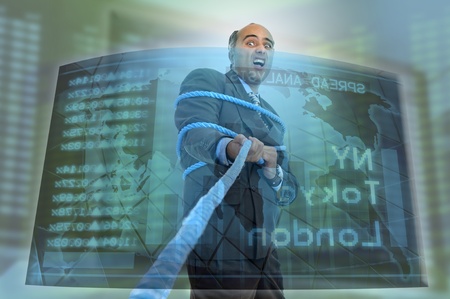 Businessman or stock broker pulling a ropeの写真素材