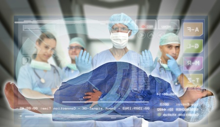 Doctors team with pregnant pacient in medical facilities with modern screenの写真素材