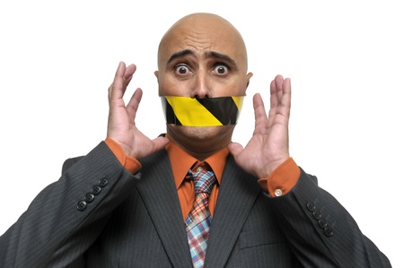 Businessman portrait with duct tape in is mouthの写真素材