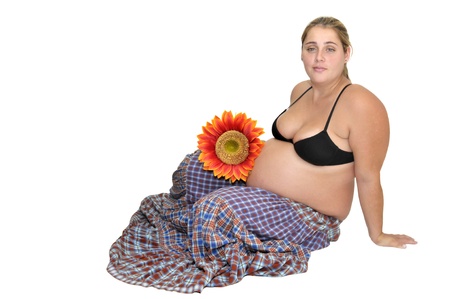 Pregnant woman with flowers isolated in whiteの写真素材