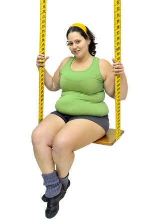 Large girl in a swing made of measuring tape の写真素材