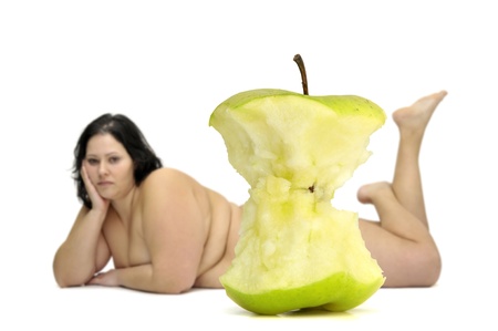 Eaten apple with beautiful nude large girl in the backgroundの写真素材