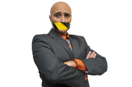 Businessman portrait with duct tape in is mouthの写真素材