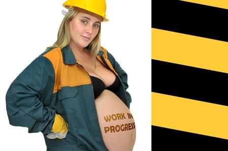 Pregnant woman in worker's jumpsuit isolated in whiteの写真素材