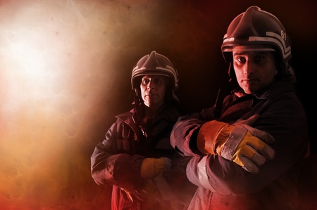 Dramatic image of firemen team in uniformの写真素材