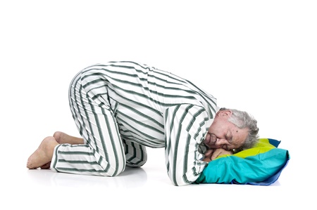 Senior man in pajamas isolated in white