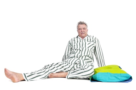 Senior man in pajamas isolated in whiteの写真素材