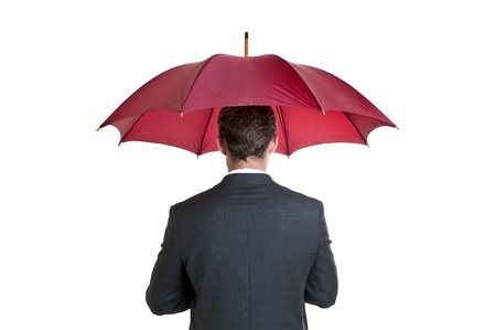 Young businessman with umbrella isolated in whiteの写真素材