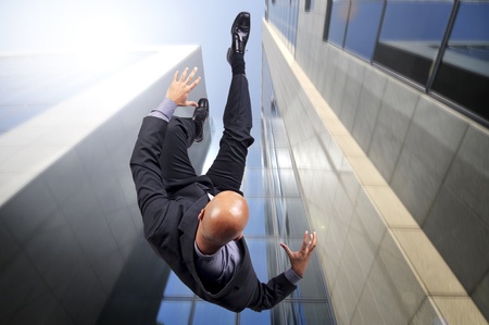 Businessman falling from a tall buildingの写真素材