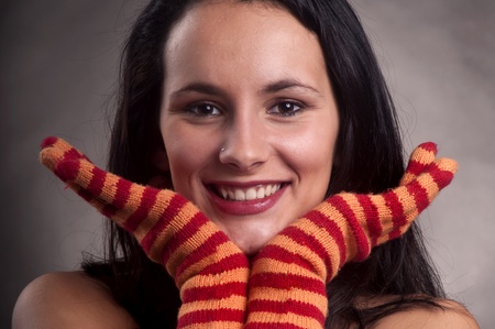 Beautiful young woman posing with colorful glovesの写真素材