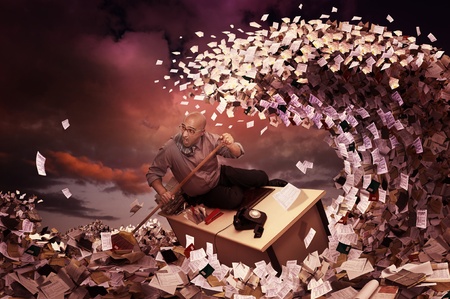 Stressed businessman in a bureaucracy sea, made of papersの写真素材