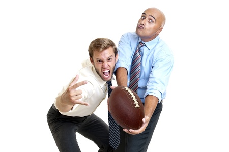 Businessman with rugby ball posingの写真素材