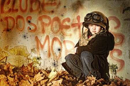 Young boy in a war zone crying for helpの写真素材